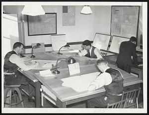 Plotting the Weather--Meteorologists Boston's new weather forecasting center charting weather movements across the nation on some of the 15 or 20 maps they draw daily to aid in predicting local weather condition.