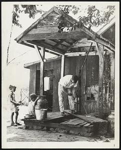 Farmers Return to Old Oaken Bucket as Drought Drains Wells. Farmers in nearby Maryland have been forced to return to the primitive method of dipping water from their wells with a bucket suspended from a rope, because of the water having sunk so low due to the continued drought that the pumps are no longer able to raise it. Photo shows Irving Briggs raising water from his well near Montrose, Md, a short distance from the Capital City.