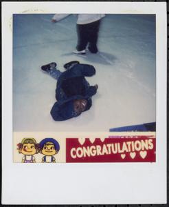Smiling boy fallen on the ice