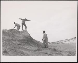 Three boys playing at the beach