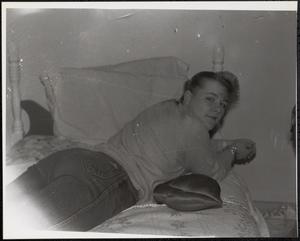 Young woman lounging on bed