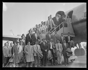 Group of men in front of plane