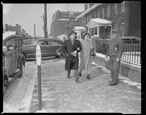 Unidentified people on sidewalk
