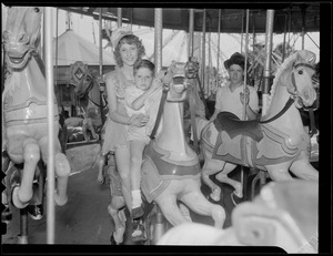 Unident. woman and boy on carousel