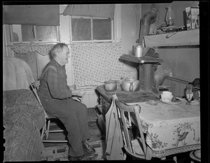 Old man in front of stove
