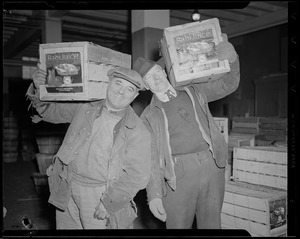 2 men carrying crates