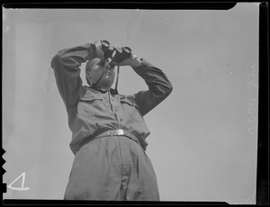 Unidentifed man looking through binoculars