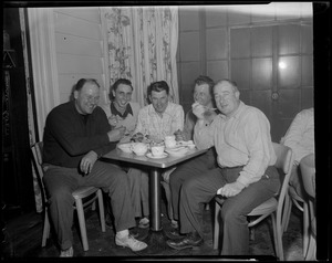 5 men eating at a table