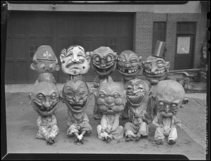 Children wearing grotesque heads