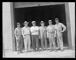 Workmen in front of garage