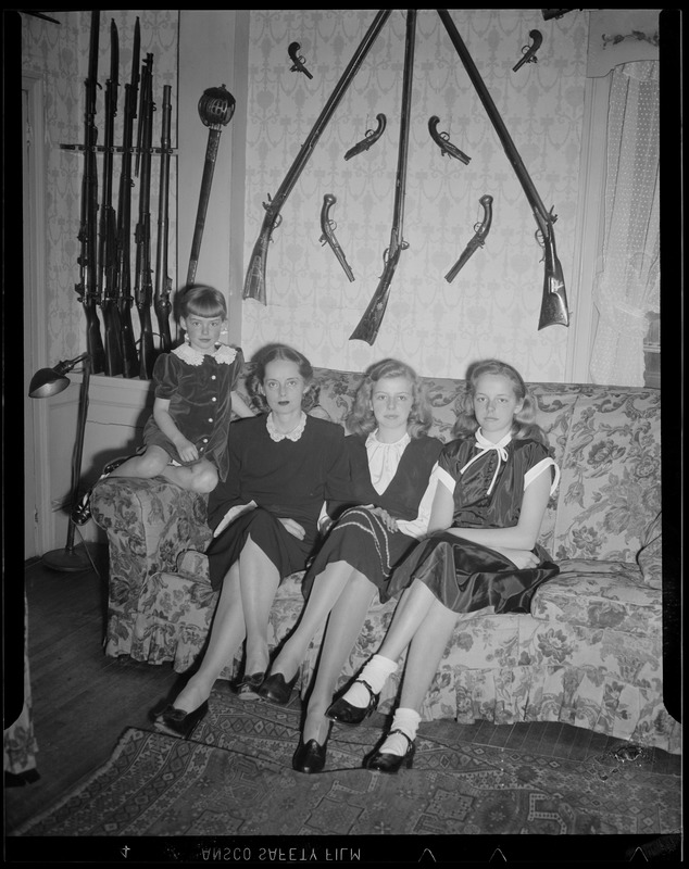 Girls on couch with weapons