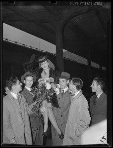 Woman given a lift and some flowers from the boys at the station