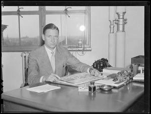 Unident. man seated at desk