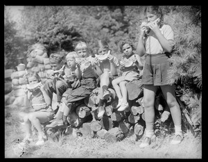 Kids eating watermelon at clam bake presided over by Alfred Keith, Little Sandy Pond, Bryantville section of Pembroke