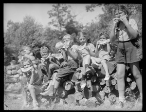Kids eating watermelon at clam bake presided over by Alfred Keith, Little Sandy Pond, Bryantville section of Pembroke