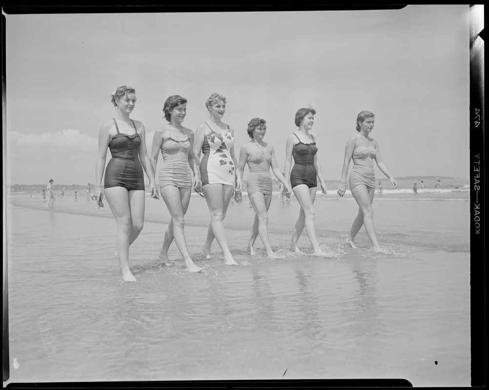 Bathing girls walk on beach