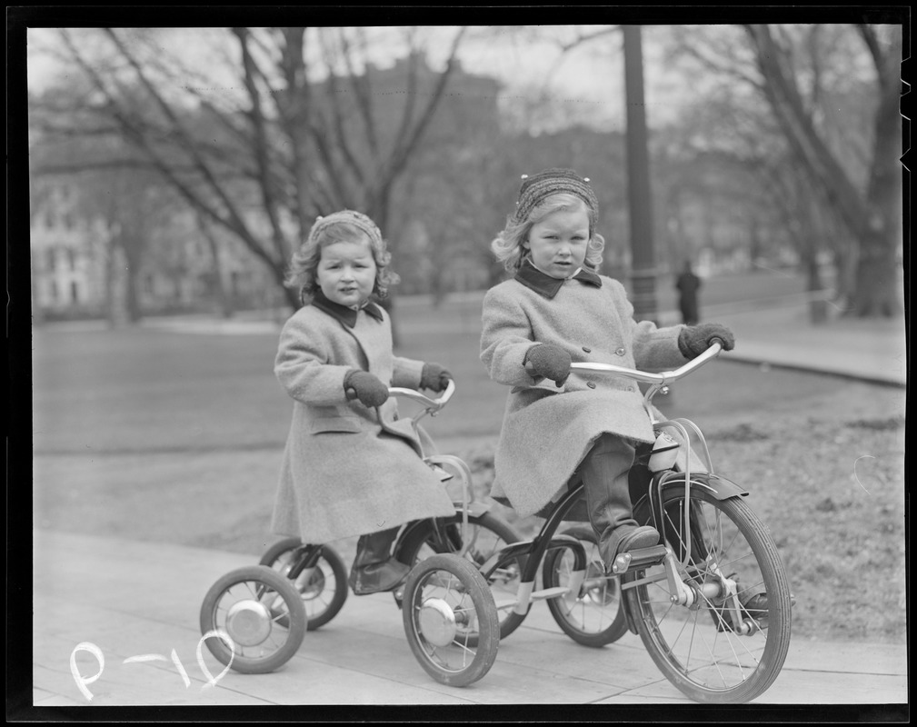 Little girls on tricycles