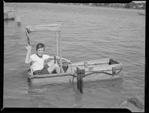 Boy in home-made boat