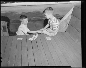 Boys playing cards on stoop