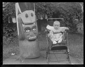 Baby in carriage with totem pole