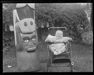 Baby in carriage with totem pole