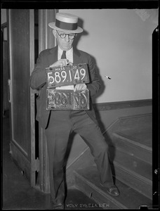 Man holding license plates
