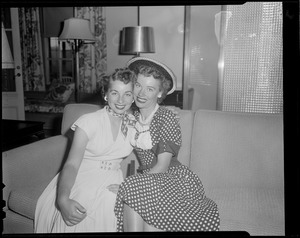 Two women pose for camera
