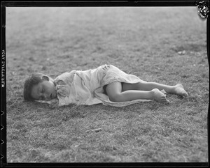 Boy sleeping on grass