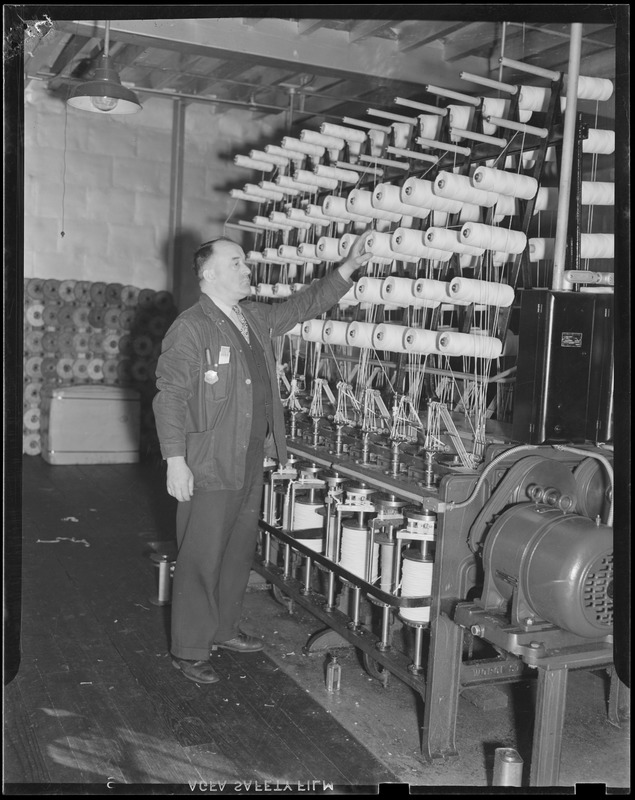 Edward Carey - leading man, standing beside cotton forming machine. He has been at this work 20 years.