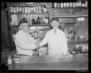 Martin Leonard, age 74, Andy Harrington, age 80, behind bar opening oysters