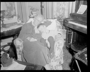 Older woman and child asleep in armchair
