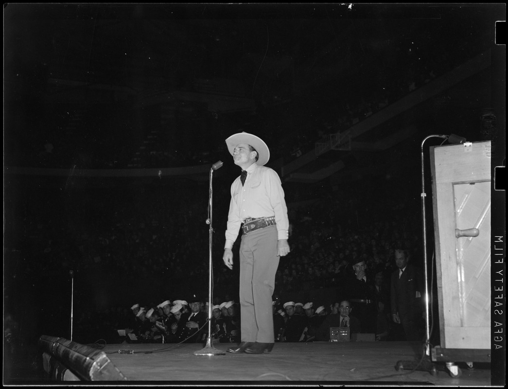 Buck Jones, cowboy star, performing
