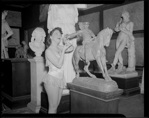 Miss Shaw, model and tease, visits studio of statues
