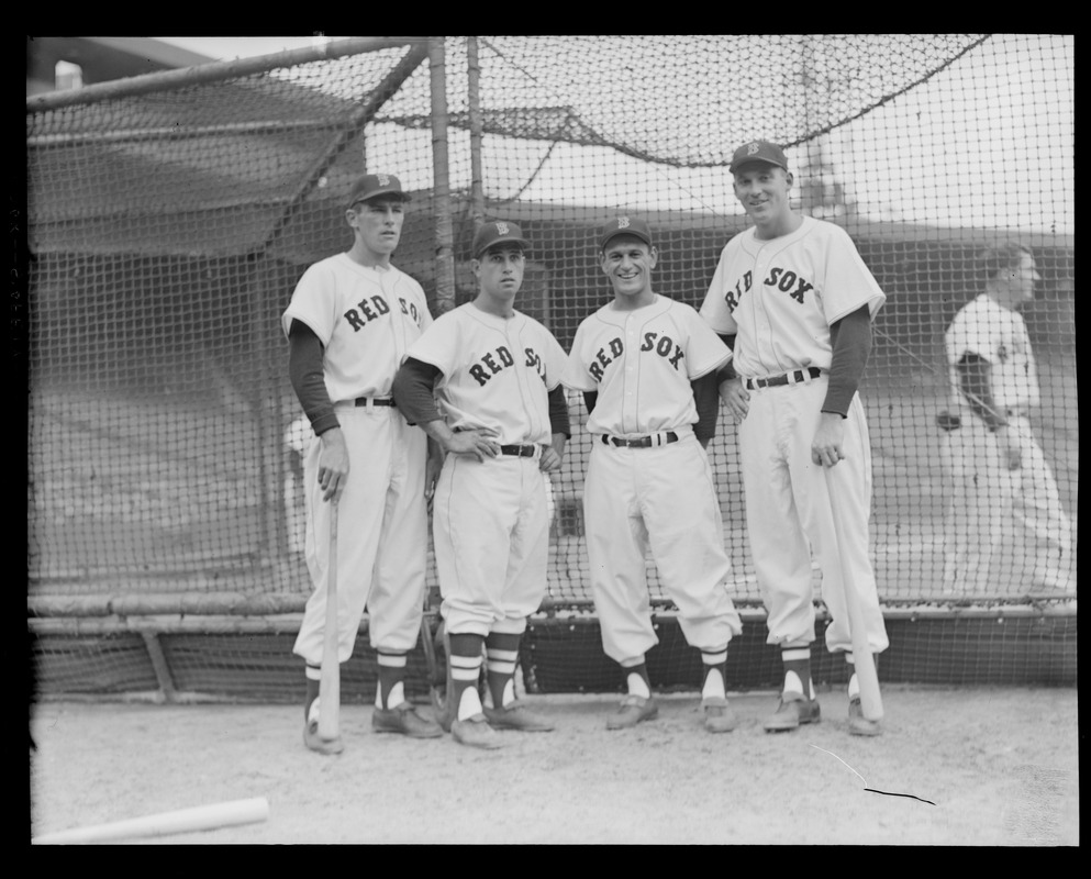 Red Sox players next to batting cage on Opening Day at Fenway