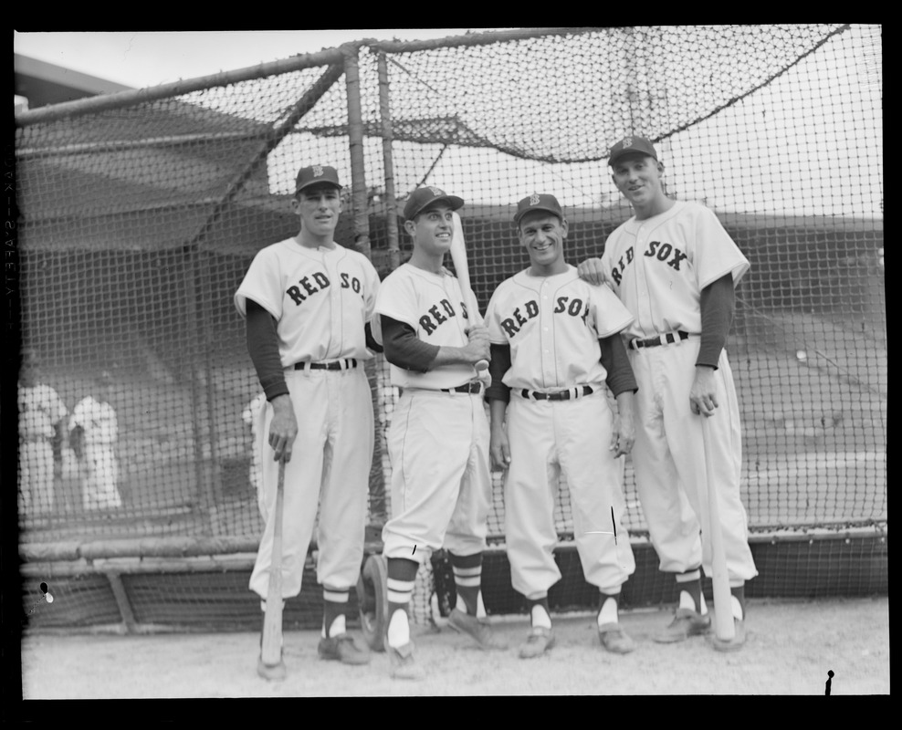 Red Sox players next to batting cage on Opening Day at Fenway