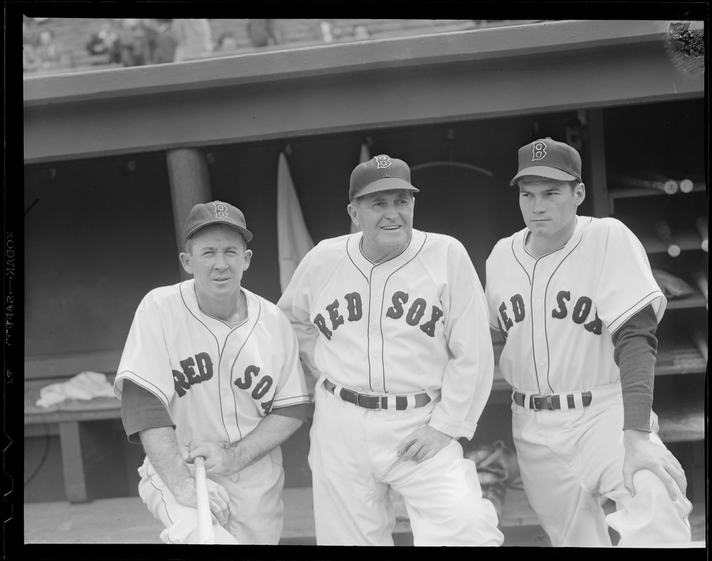 Two Red Sox players in dugout with manager McCarthy