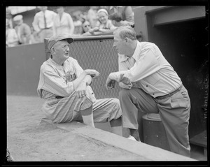 Cy Young and Lefty Grove talk in dugout at Old-Timers' Game