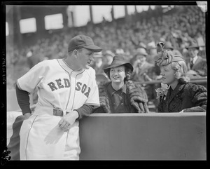 Red Sox manager Joe Cronin talks with two ladies seated in the stands at Fenway