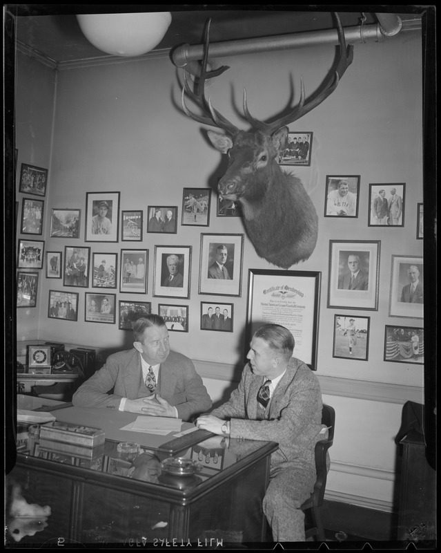 Eddie Collins of the Sox talks with man at his desk