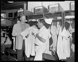 Red Sox player and attendant in clubhouse at Fenway