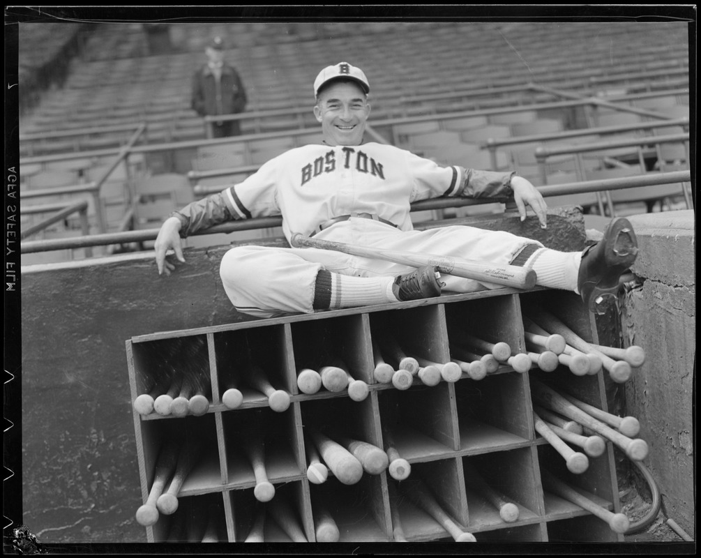 Boston Bees player sits on bat rack at Braves Field