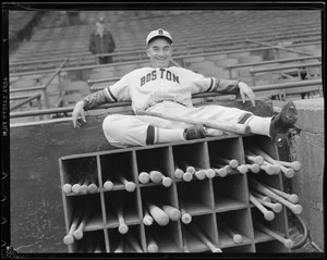 Boston Bees player sits on bat rack at Braves Field