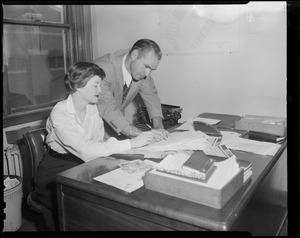 New manager for the Braves, Tommy Holmes, goes over some paperwork