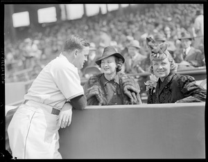 Joe Cronin, Sox manager, talks to ladies in stands at Fenway