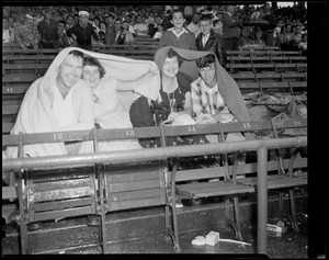 Fans cover up at rainy Fenway