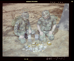 Food lab, 2 G.I. eating ration in woods