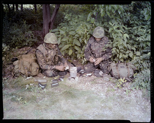 Food lab, new meal, ready to eat, out in field with GI opening pack & heating food