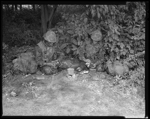 Food lab, new meal, ready to eat, out in field with G.I. opening food pack