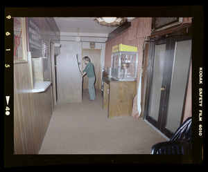 Man playing arcade game in hallway