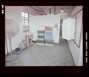 Interior with partition, baseball bats and stack of coolers